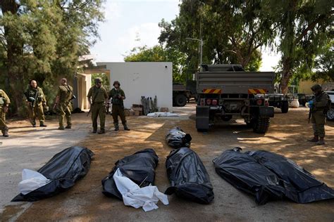 After clearing one kibbutz, Israeli soldiers find slain children